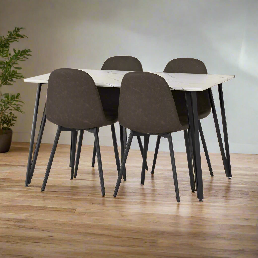 A dining table featuring a white marble top, accompanied by four elegant chairs arranged around it.