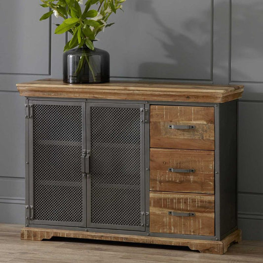 An industrial-style sideboard with two doors and a vase as a decorative accent.