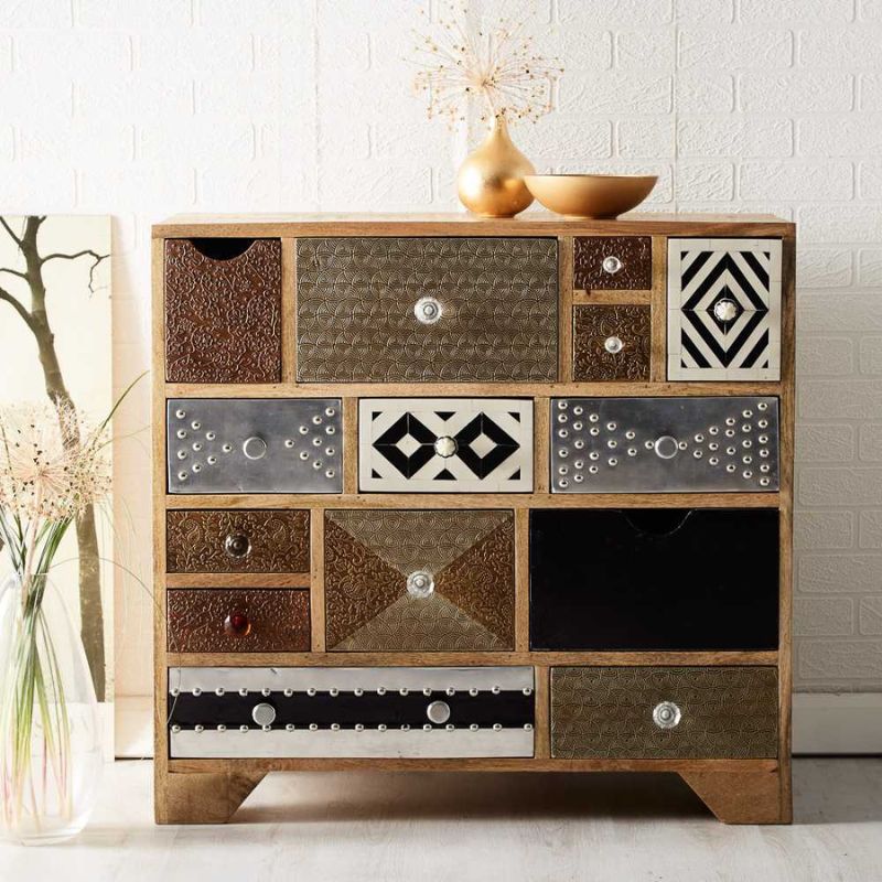 Wooden chest with multiple drawers and a vase on top.