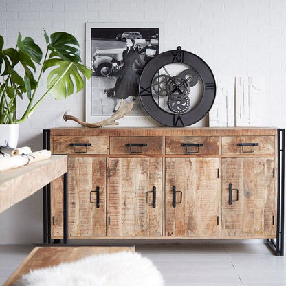 A rustic sideboard with a clock and a plant.