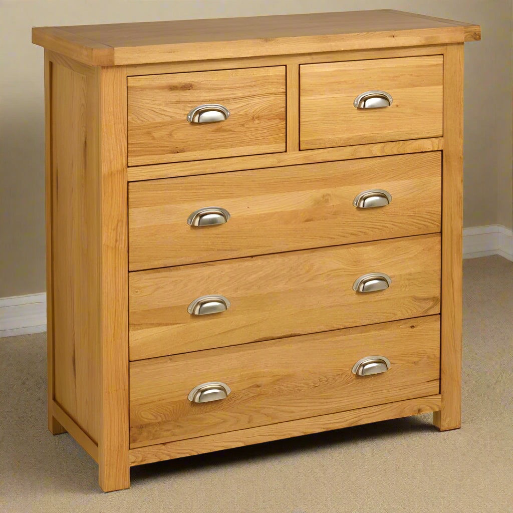 A wooden chest of drawers with four drawers and two handles.