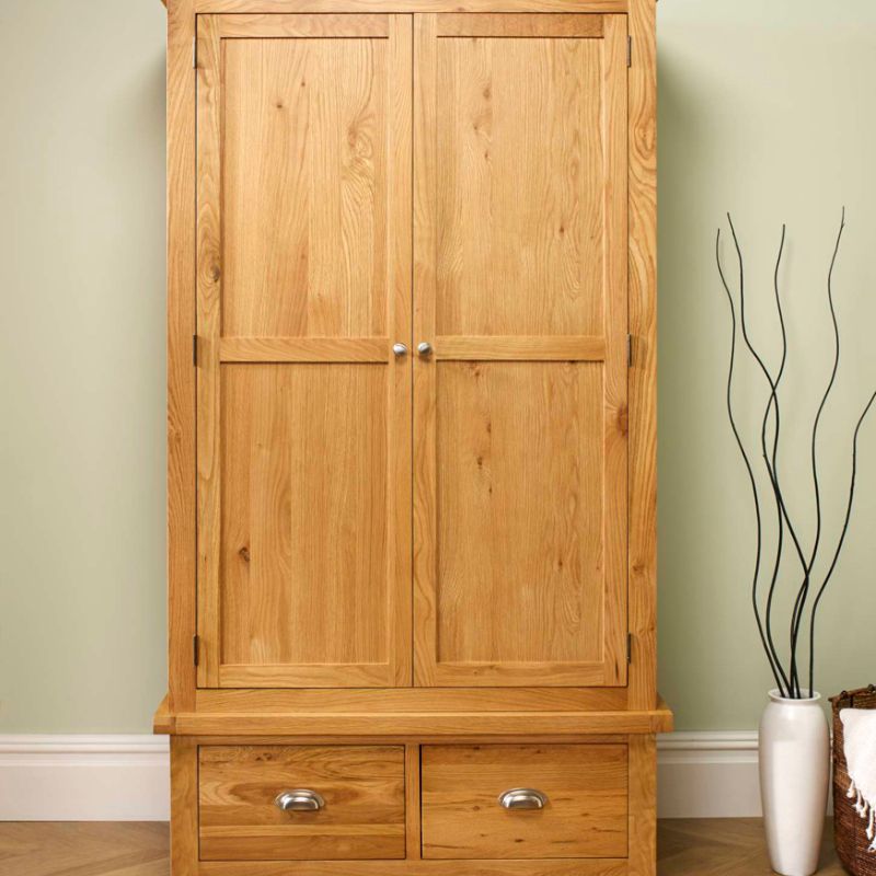 Wooden armoire with drawers and a vase on top.