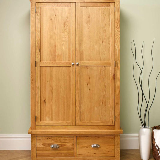 Wooden armoire with drawers and a vase on top.