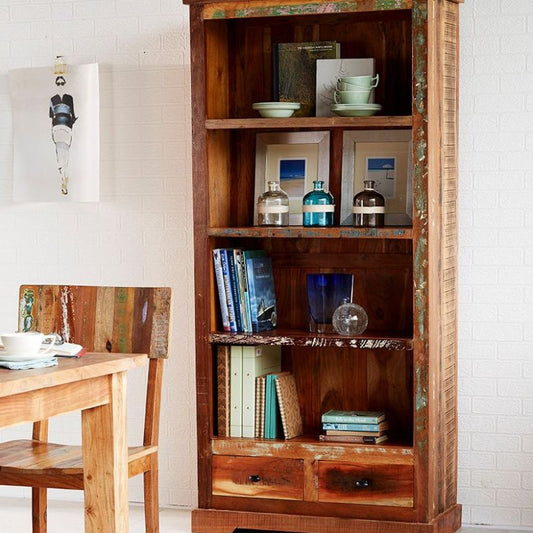 Wooden bookcase, table, and chairs in a cozy room setting.