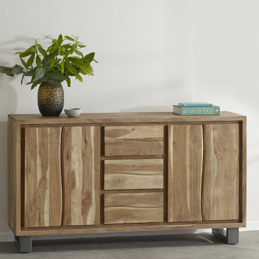 A wooden sideboard with drawers, adorned with a plant in a white pot.