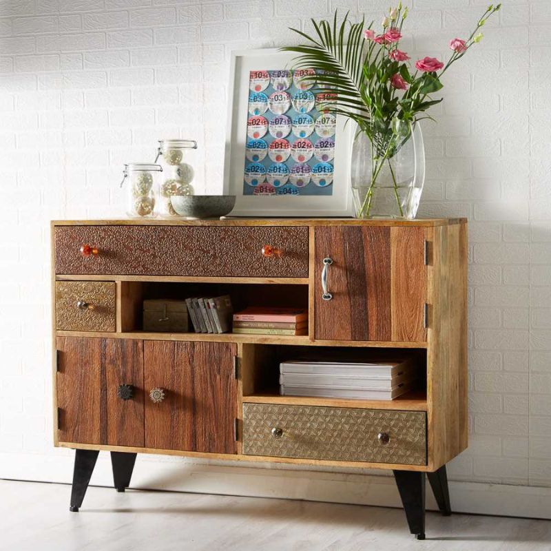 A wooden sideboard with drawers and a floral arrangement.