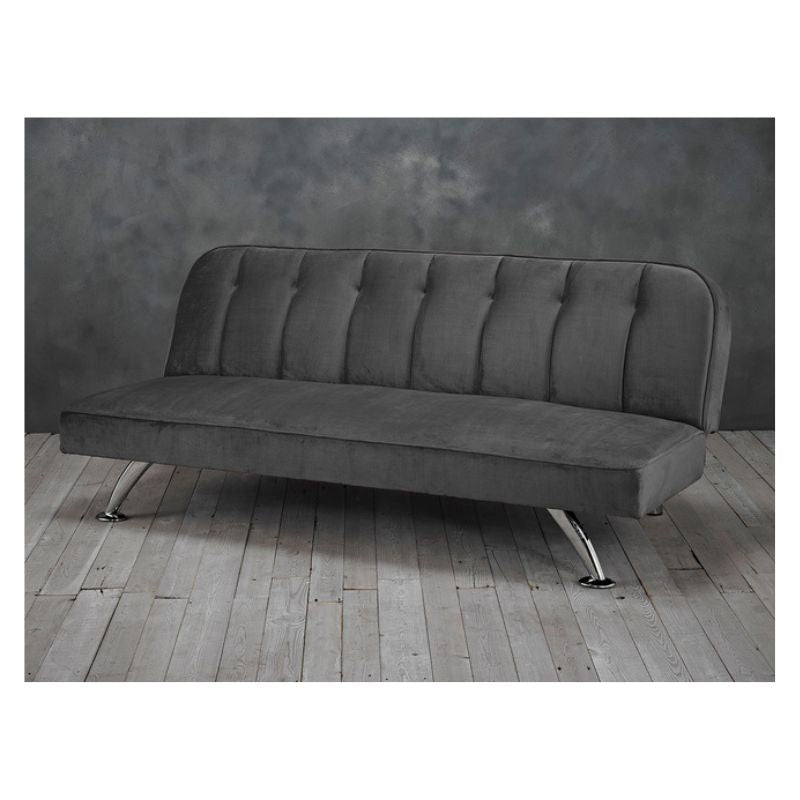 A grey sofa with metal frame and buttoned up seat.