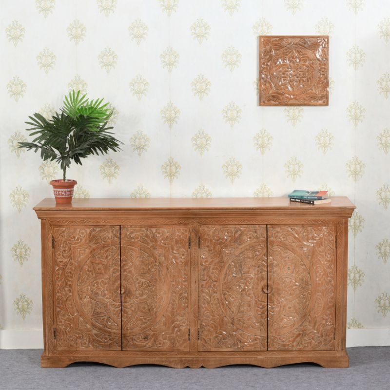 A wooden sideboard with a potted plant on top.