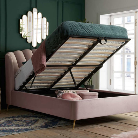 A pink bed with a storage box underneath it.