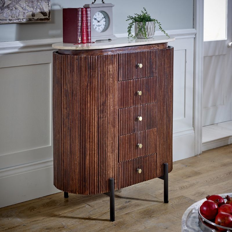  A rustic wooden cabinet with several drawers and a vintage clock.