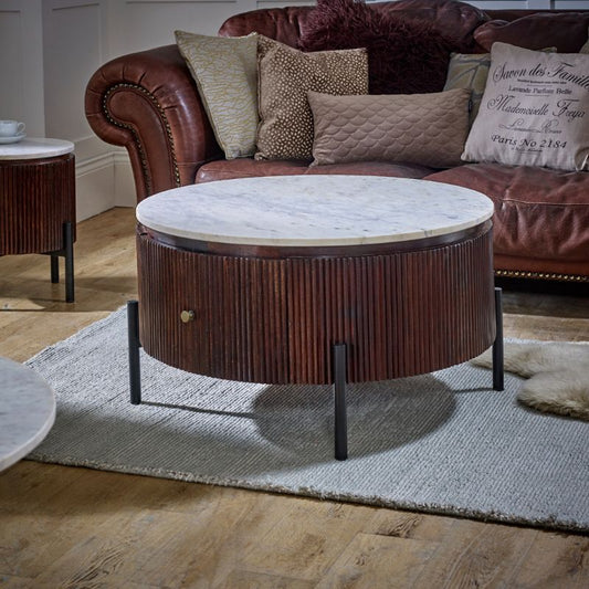 A cozy living room with a couch, coffee table, and two end tables.