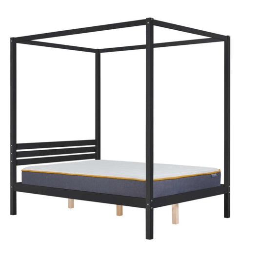 A black canopy bed with a mattress on top.