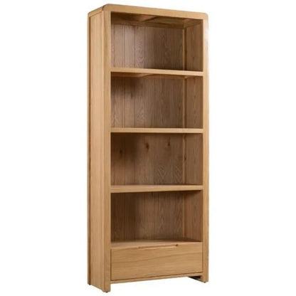 A wooden bookcase featuring three shelves, elegantly displaying books and decorative items in a warm, inviting setting.