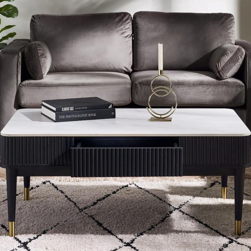 A sleek modern coffee table featuring a stylish black and gold frame, enhancing contemporary interior decor.