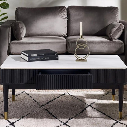 A sleek modern coffee table featuring a stylish black and gold frame, enhancing contemporary interior decor.