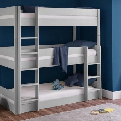 A stylish bunk bed positioned in a room with blue walls, featuring elegant white furniture for a fresh and modern look.