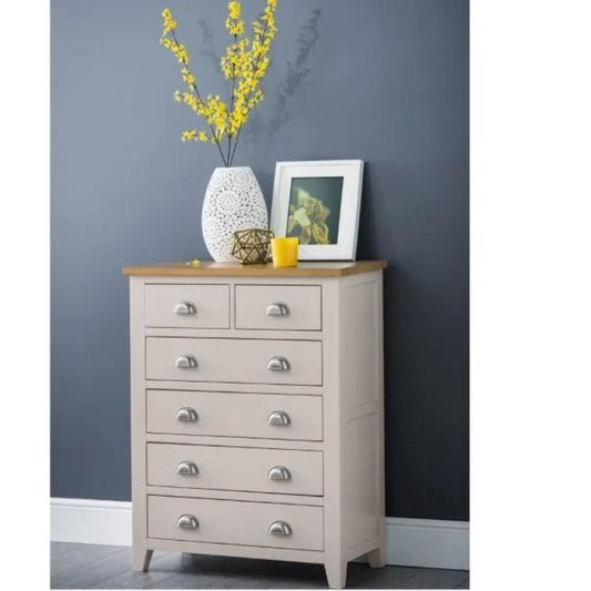 A stylish oak and cream chest of drawers, featuring elegant design and ample storage space for organizing belongings.