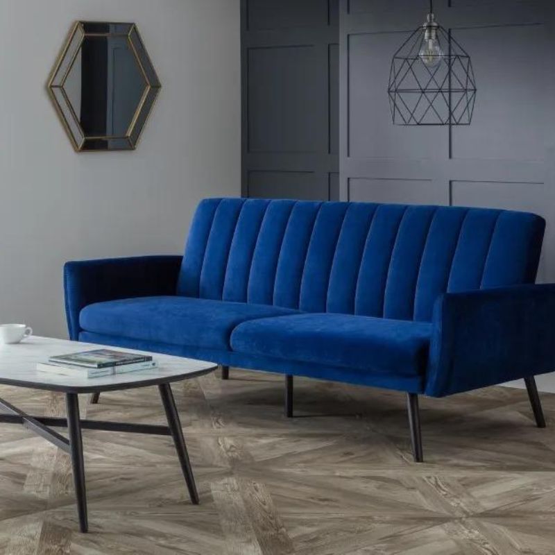 A modern blue velvet sofa featuring sleek black legs, showcasing a stylish and contemporary design for any living space.