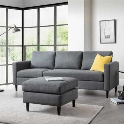 A stylish grey sofa and matching ottoman enhance the comfort of a modern living room.