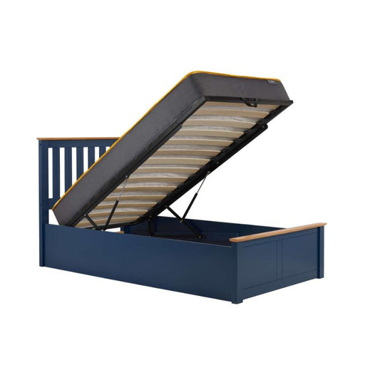 A stylish navy bed equipped with a mattress and practical storage compartments located beneath for added functionality.