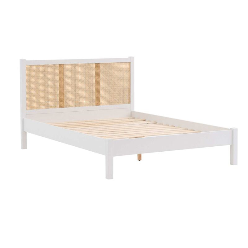 A white bed featuring a wooden frame and a woven headboard, elegantly designed for a stylish bedroom setting.