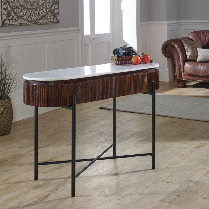 A stylish table featuring a sleek marble top supported by elegant metal legs, perfect for modern interiors.