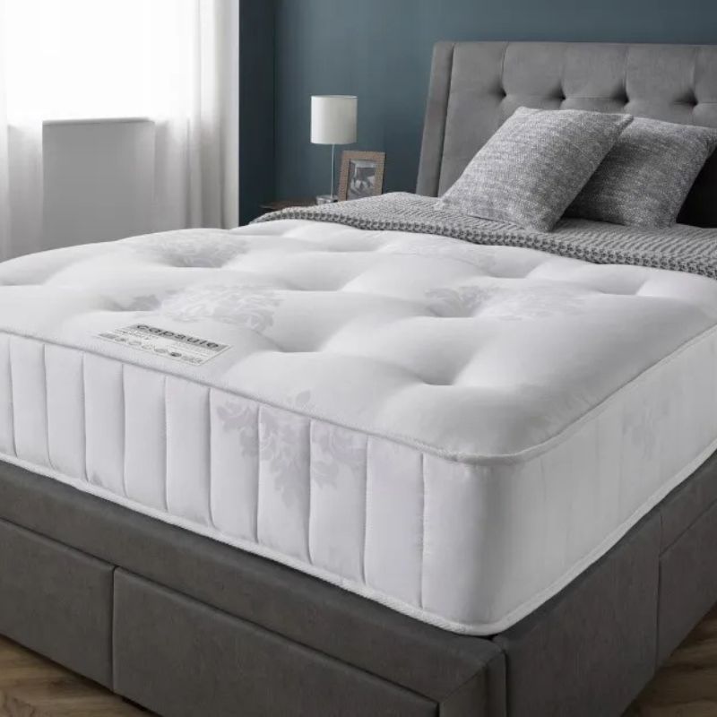 A mattress adorned with a fresh white cover, highlighting a serene and inviting sleeping surface.