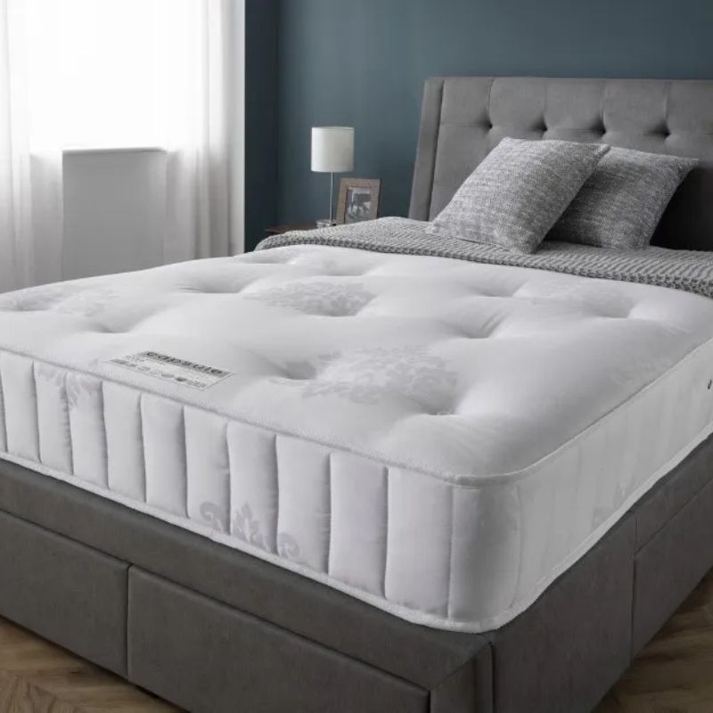 A mattress covered with a crisp white cover, showcasing a clean and minimalist aesthetic.