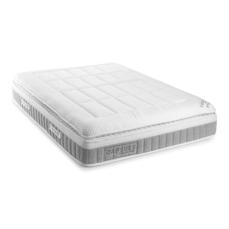 A white mattress displayed prominently, showcasing its clean and simple design.