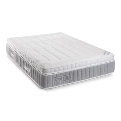 A white mattress displayed prominently, showcasing its clean and simple design.