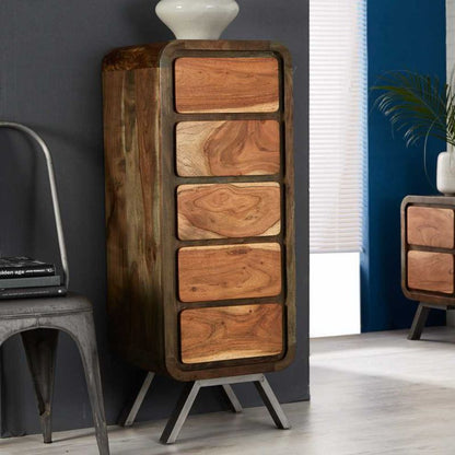 Wooden chest of drawers with chair and lamp.