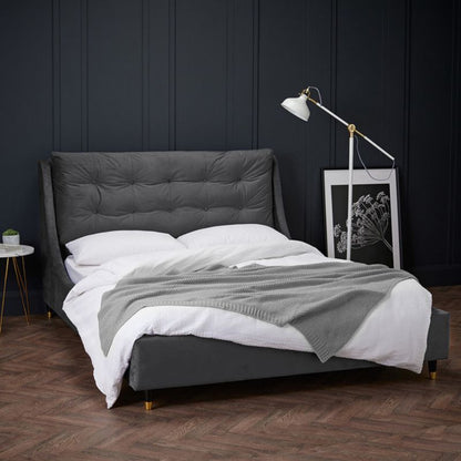 Modern bed with matching grey headboard and bedding.