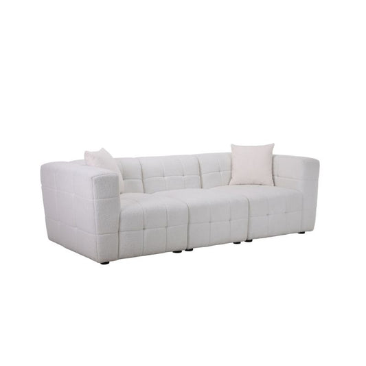 A white sectional couch adorned with decorative pillows, creating a cozy and inviting living space.