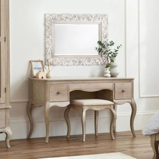 A cozy bedroom featuring a stylish dressing table with an elegant mirror, creating a serene and inviting atmosphere.