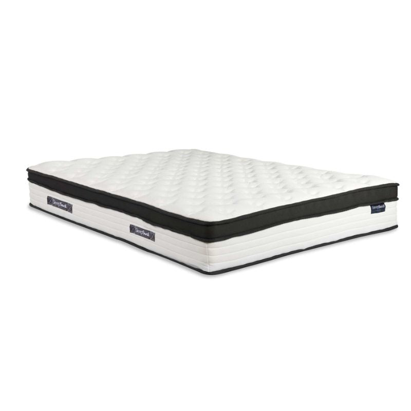 A white and black mattress displayed prominently, showcasing its modern design and contrasting colors.