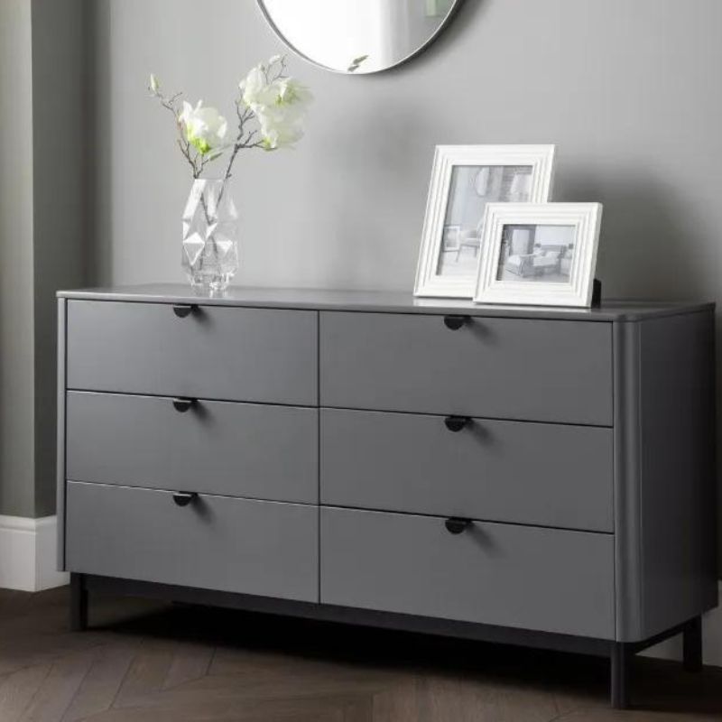 A grey dresser featuring multiple drawers and a mirror, elegantly designed for functional and stylish storage.