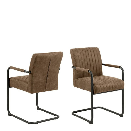 Two brown leather chairs with metal frame in a modern living room.