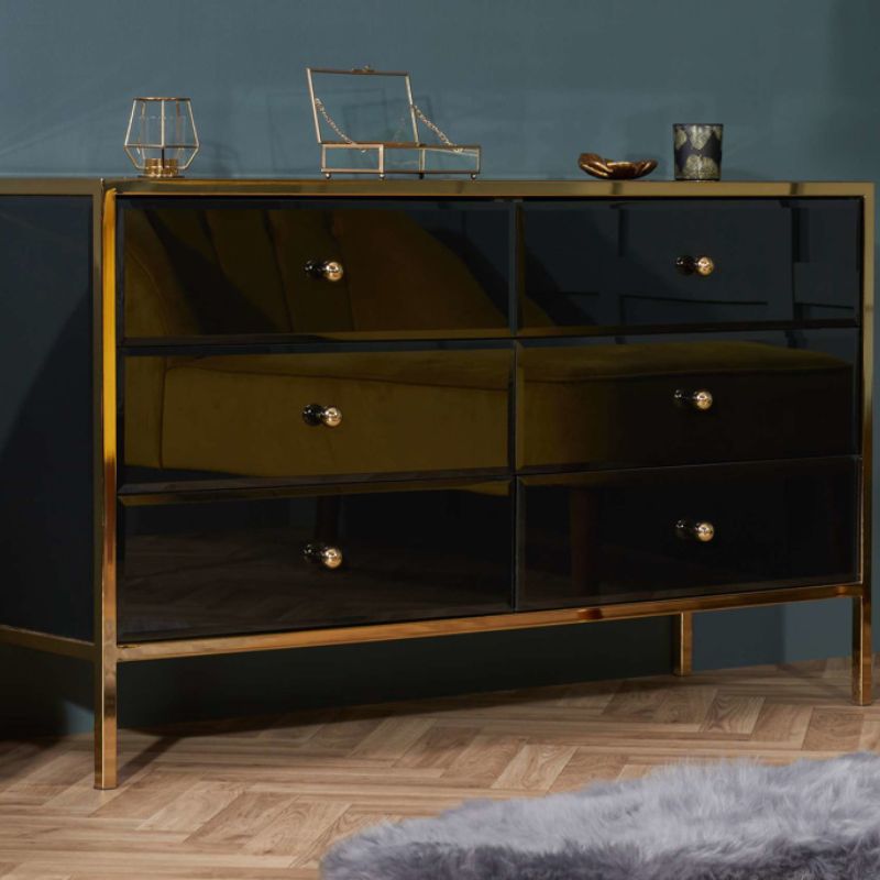 A black and gold dresser with drawers, adding a touch of elegance to any room.