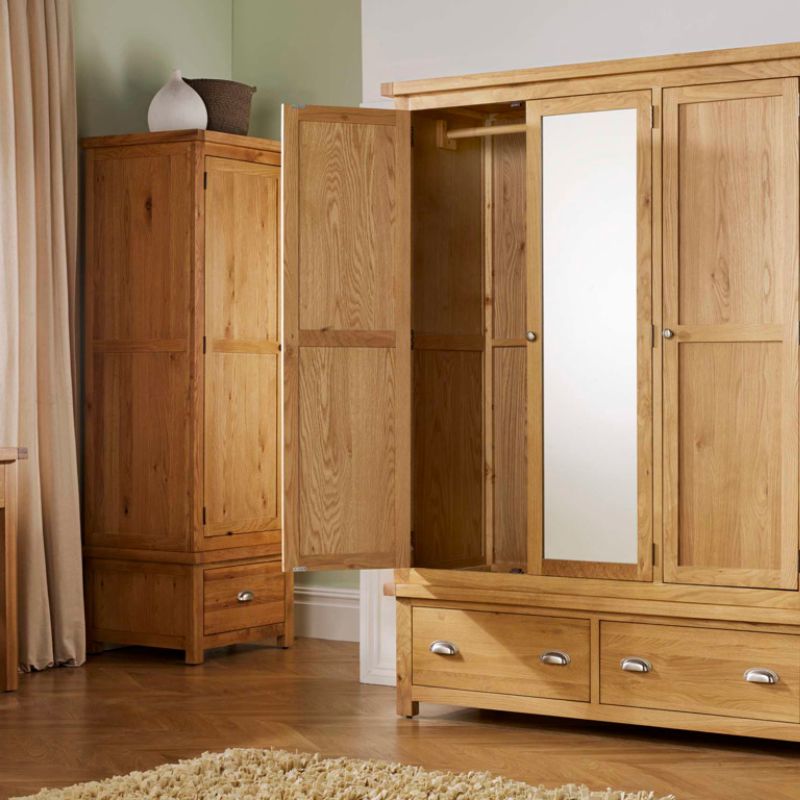 A wooden wardrobe with drawers and mirror.