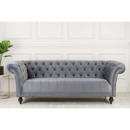 Grey velvet Chesterfield sofa, elegant and luxurious furniture piece for stylish living rooms.